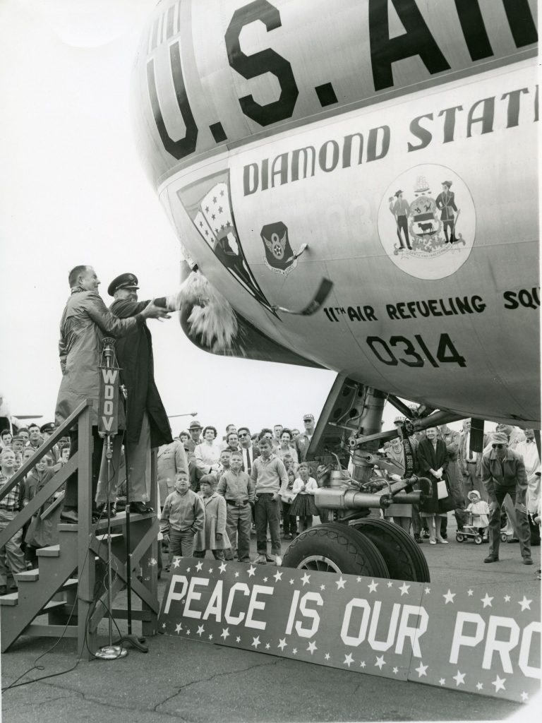 Governor Carvel (on the left) christening “Diamond State Tanker” with Staff Sgt. Goodin Armed Forces Day, Dover Air Force Base, May 25, 1961 