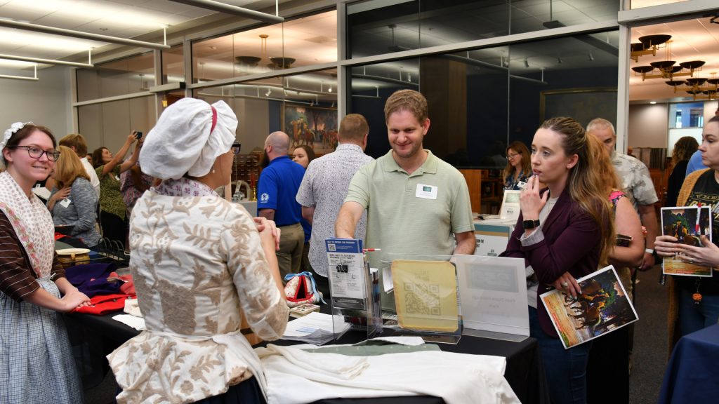 First State Heritage Park staff Nicole Hutchinson and Nicole Worthley display artifacts and share handouts with participants.