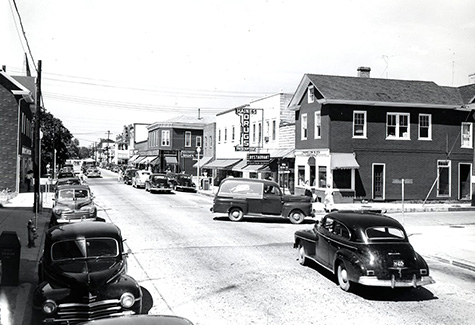 an old photo of a street with cars