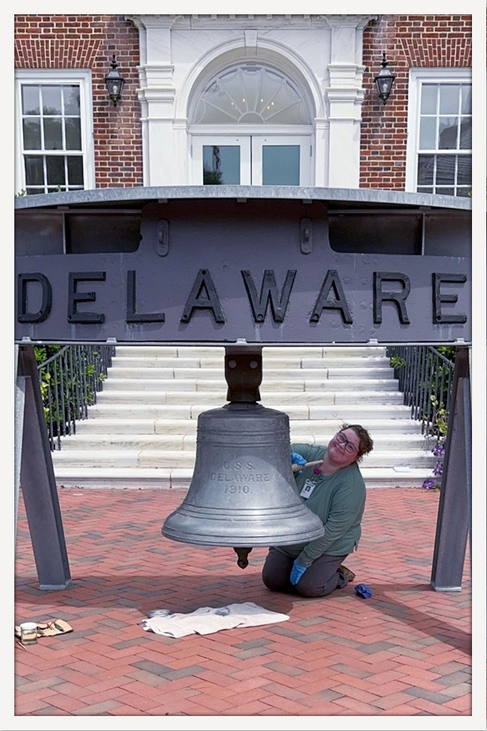 Archives staffer applies new wax to bell