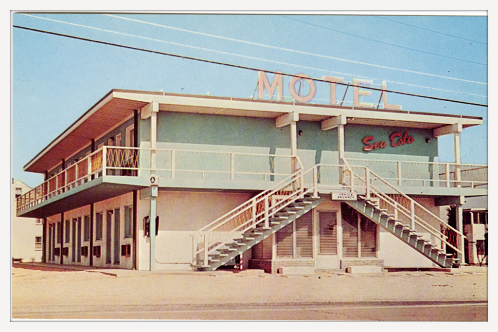 Postcard of the Sea-Esta Motel in Dewey Beach, Delaware, showing the building with an empty parking lot.