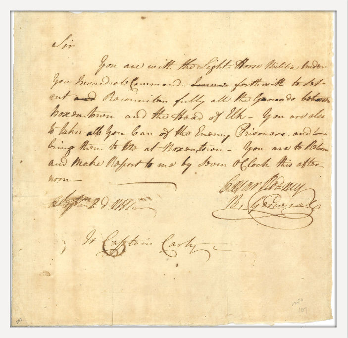 Handwritten military orders signed by Caesar Rodney, directing Captain Isaac Carty and his cavalry troop to scout British movements. The document is written in flowing script on aged paper.