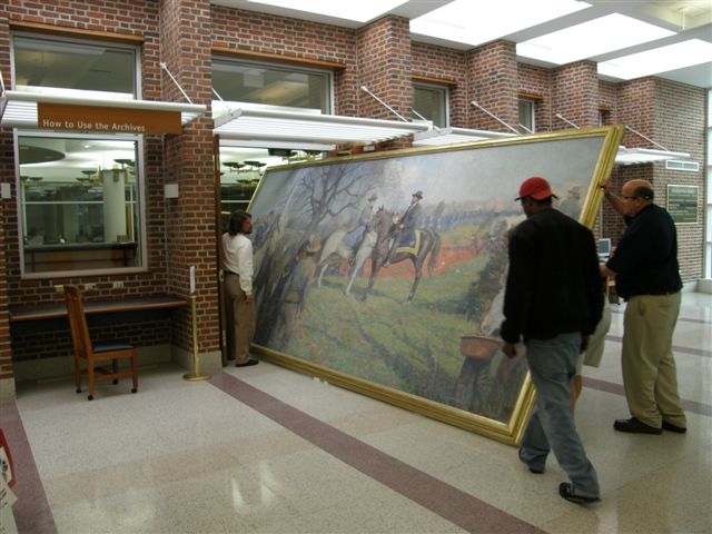 Three men carefully move The First Day of Peace in the Archives building lobby, through the double doors into the Research Room.