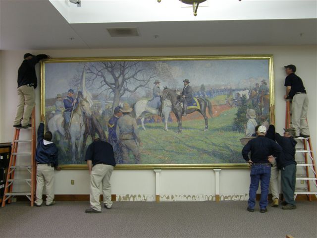 Several men on ladders install the large painting, The First Day of Peace.