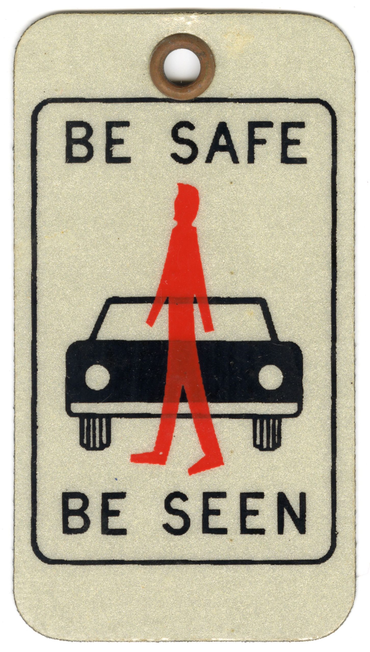 Keychain tag featuring a red silhouette of a man superimposed over a black car with the words "Be Safe. Be Seen."