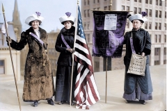 Women holding Suffrage banner and US flag